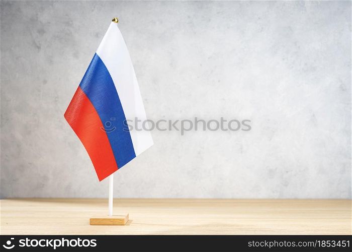 Russia table flag on white textured wall. Copy space for text, designs or drawings