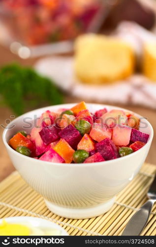Russian beetroot salad made of beetroot, potato, carrot, pea and a mayonnaise dressing (Selective Focus, Focus on the top of the vegetables in the middle) . Russian Beetroot Salad