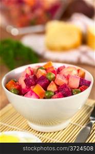 Russian beetroot salad made of beetroot, potato, carrot, pea and a mayonnaise dressing (Selective Focus, Focus on the top of the vegetables in the middle) . Russian Beetroot Salad