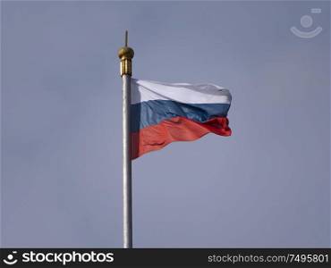 Russian flag fluttering in the wind on a flagpole.. Russian flag fluttering in the wind on a flagpole