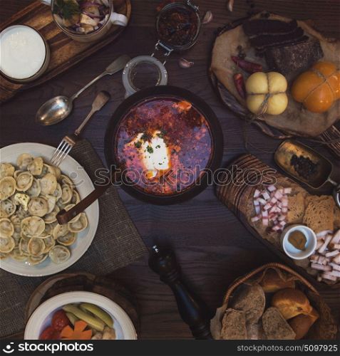 Russian food table. Russian food: borsch pickles cheese meat dumplings and fat