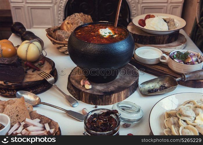 Russian food table. Russian food: borsch pickles cheese meat dumplings and fat