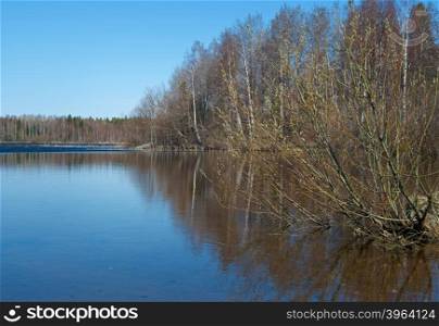 Russian landscape Arkhangelsk Oblast . spring flooding on the lake,Thin ice on the water