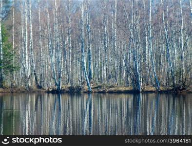 Russian landscape.Spring flooding on the river,Reflection of trees in water.