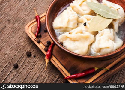 Russian meat dumplings pelmeni on wooden rustic background.Russian pelmeni. Homemade meat dumplings