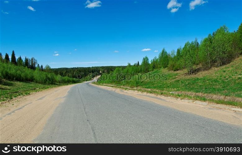 Russian rural landscape with road Distance in Forest.Arkhangelsk region of Russia