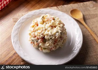 Russian Salad, also known as Oliver Salad. Very popular dish in several countries, the main ingredients are commonly potatoes, mayonnaise and vegetables such as peas, carrots, boiled eggs or chicken.