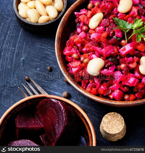 russian salad vinaigrette. Traditional vegetarian russian beetroot salad vinaigrette on slate background