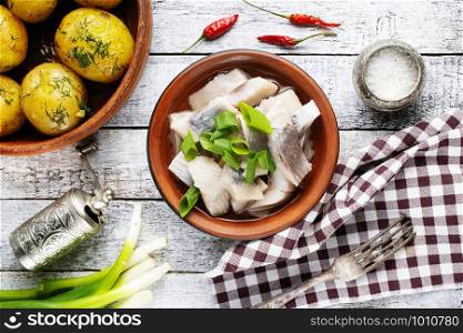 Russian traditional cuisine: salted herring with boiled potatoes