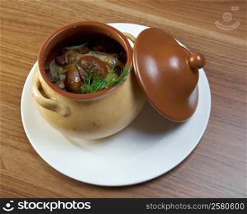 Russian vegetable vegetable stew with mushrooms in ceramic pot
