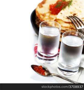 Russian vodka with pancakes and red caviar on white background