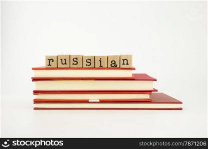 russian word on wood stamps stack on books, language and academic concept