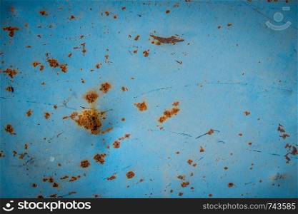 Rusted blue painted metal wall. Rusty metal background with streaks of rust