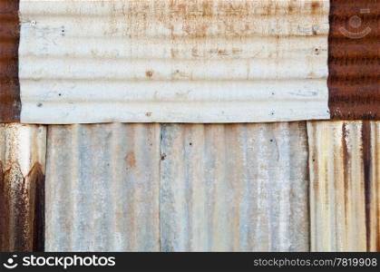 Rusted metal background of corrugated iron and tin with rivets