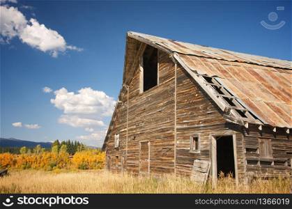 Rustic Barn Scene with Deep Blue Sky and Clouds