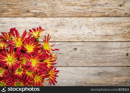 rustic barn wood background with a bouquet of fall mums and copy space