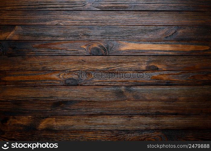 Rustic dark brown wooden table background top view