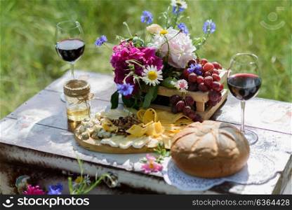 rustic decorative photo zone with suitcases, wine. cheese