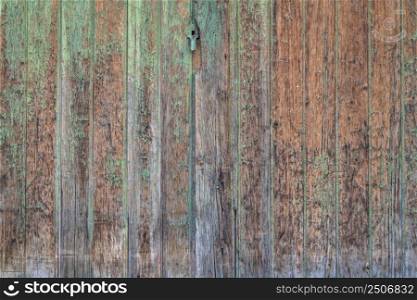 rustic grunge wooden gate painted green, retro background and texture