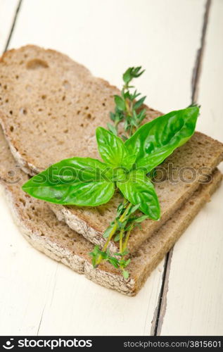 rustic Italian bread basil and thyme simple snack on white wood table