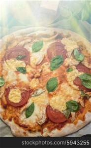 rustic italian pizza margarita. rustic italian pizza with mozzarella cheese tomato and basil leaves