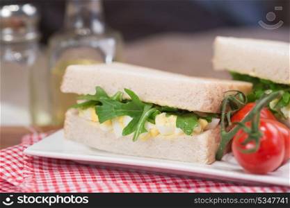 Rustic kitchen setting for fresh egg and rocket sandwich