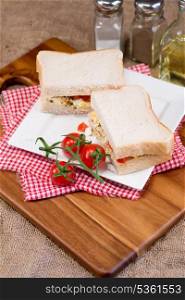 Rustic kitchen setting for fresh egg and tomato sandwich
