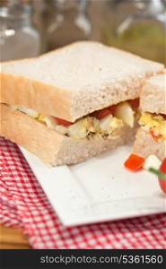 Rustic kitchen setting for fresh egg and tomato sandwich