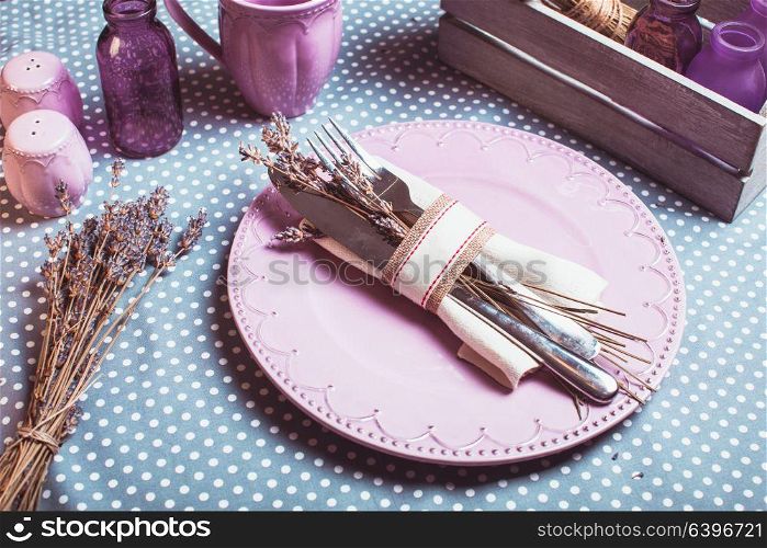Rustic lavender table serving - dry flowers and lilac dishware. Rustic lavender table serving