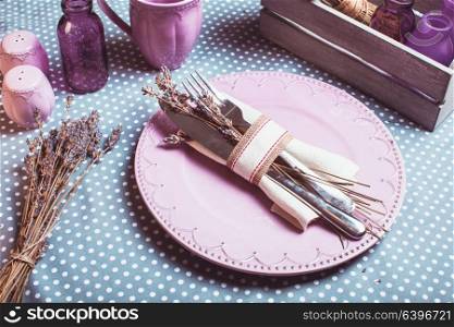 Rustic lavender table serving - dry flowers and lilac dishware. Rustic lavender table serving