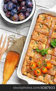 rustic meat pie. Baked according to traditional recipe meat pie with plums
