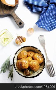 Rustic oven baked potatoes with rosemary in bowl