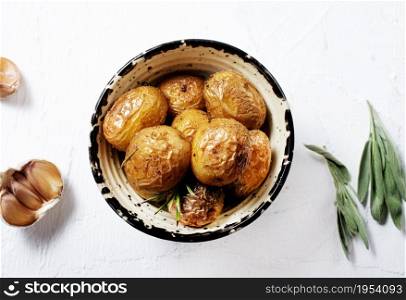 Rustic oven baked potatoes with rosemary in bowl