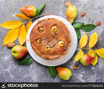 Rustic pie with pears and fallen autumn foliage. Autumn kitchen.. Homemade autumn pear cake