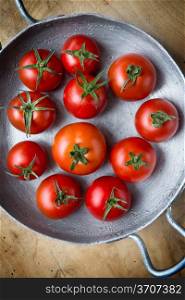 Rustic tomatoes in an iron skillet. Top view. Rustic tomatoes. Top view