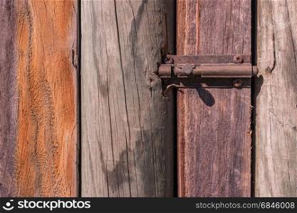 Rustic weathered barn wood background with knots with door lock