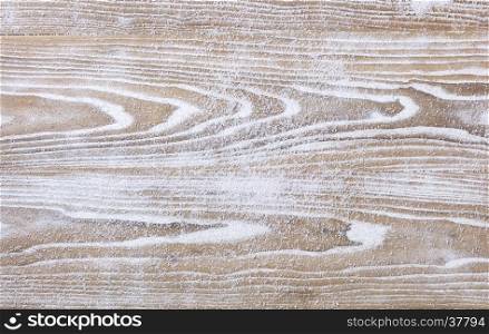 Rustic white wooden background covered in snow for Christmas concept. Overhead view with copy space.