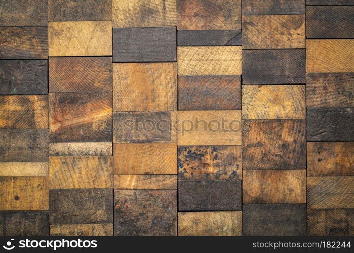 rustic wooden background - mosaic of of grunge, scratched and stained wood blcoks with a different grain pattern