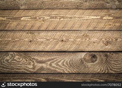 rustic wooden background - planks of weathered pine wood with strong grain pattern and knots