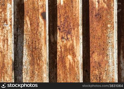 Rusty aged weathered surface of corrugated metal sheet closeup as background