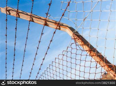 Rusty barbed wire with blue sky