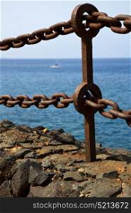 rusty chain water boat yacht coastline and summer in lanzarote spain