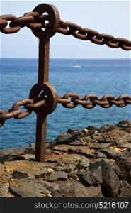 rusty chain water boat yacht coastline and summer in lanzarote spain