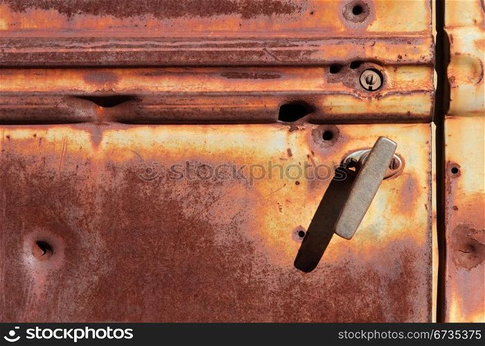 Rusty door of an old pickup truck
