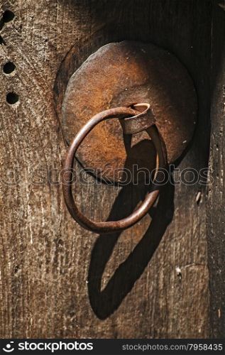 Rusty iron fittings hardware of old weathered wooden board of door