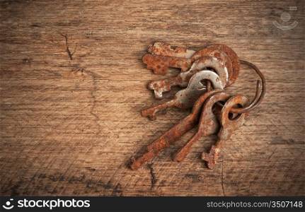 rusty keys on a wooden board