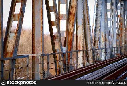 Rusty old bridge and abandoned railroad tracks