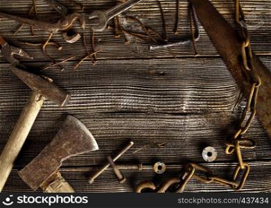 Rusty tools on old dark plank background with copyspace