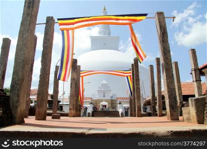 Ruwanwelisaya Ched, columns and flags in Anuradhapura, Sri Lanka