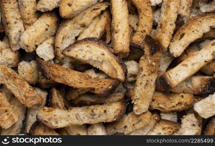 Rye bread fried croutons with garlic as background. Close up view.
